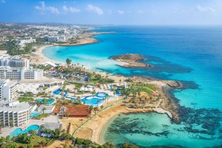 Ayia Napa coastline with turquoise sea and beach resorts.