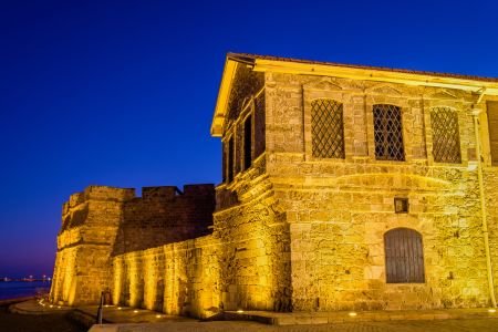 Larnaca Castle and seafront promenade lit up at night, Cyprus. Retiring in Cyprus