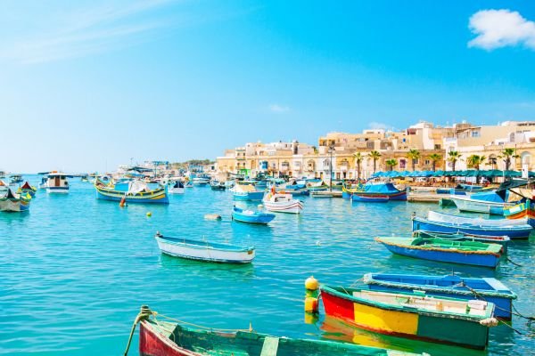 Marsaskala harbour, Malta – colourful boats and quiet waterfront homes. Retiring in Malta