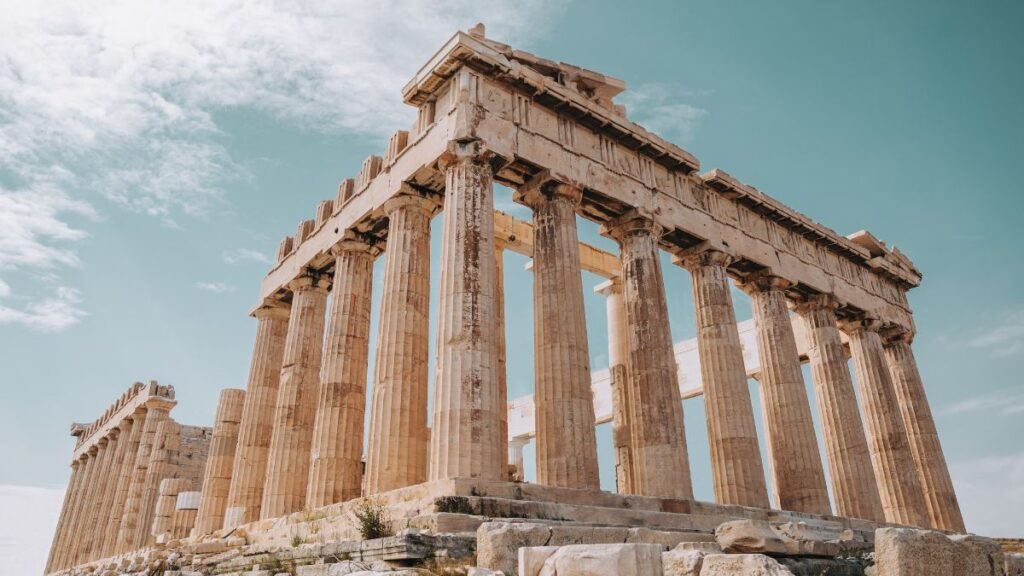 The Parthenon temple on the Acropolis hill in Athens under a blue sky. Retiring in Greece