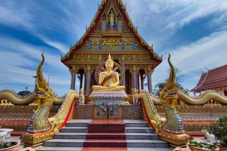 Retiring in Thailand: Golden Buddha and temple with Naga statues