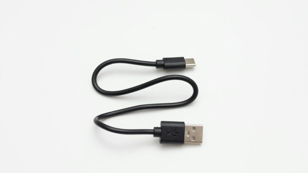 Short black USB-A to USB-C charging cable on a white background representing a the best travel cables